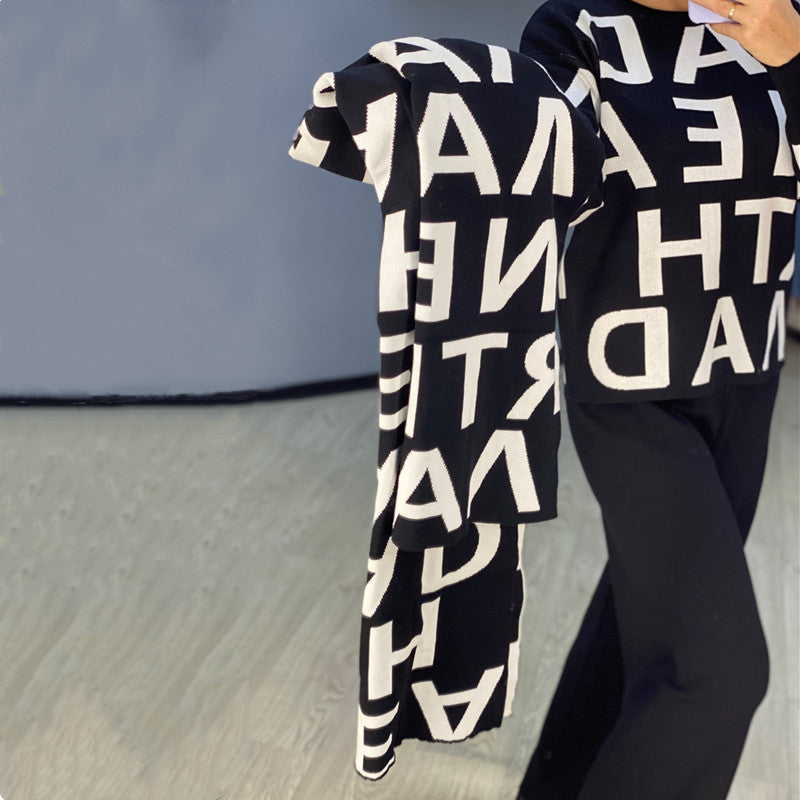 Black women's sport winter suit by Agate featuring a cozy sweater and athletic clothing for cold weather outdoor activities.