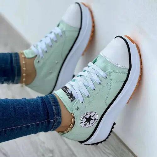 Light green Silver Juneberry lace-up sneakers with patterned canvas design, casual women’s sport shoes with flat soles.