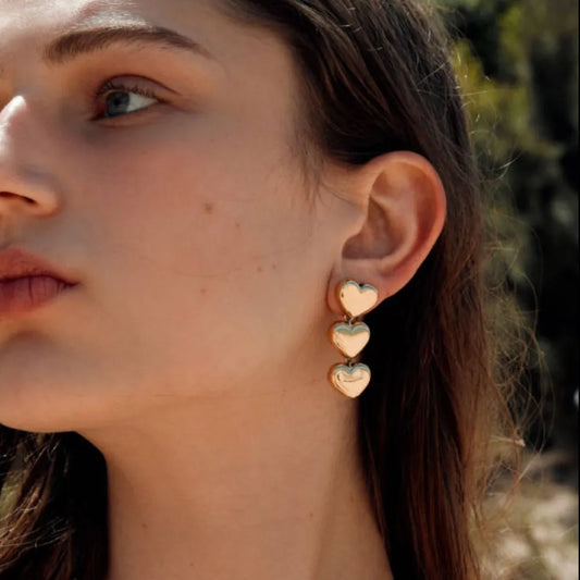 Gold stainless steel heart earrings by Trendsi, featuring a sleek, modern design with a polished finish.