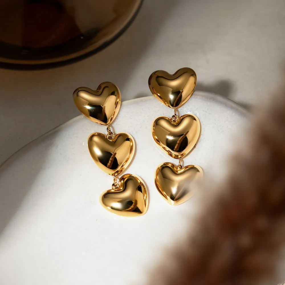 Gold stainless steel heart earrings with a sleek, modern design, perfect for everyday wear and stylish accessories.