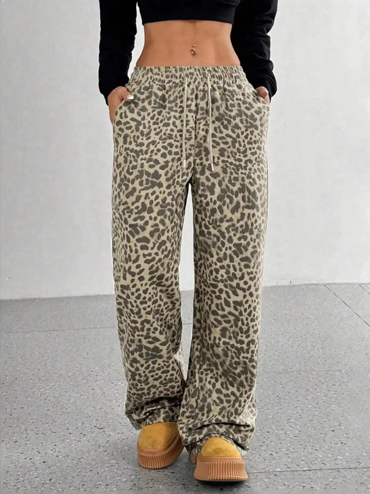 Plus size leopard print wide-leg pants from Trendsi, showing full length with a relaxed fit and bold animal print pattern.