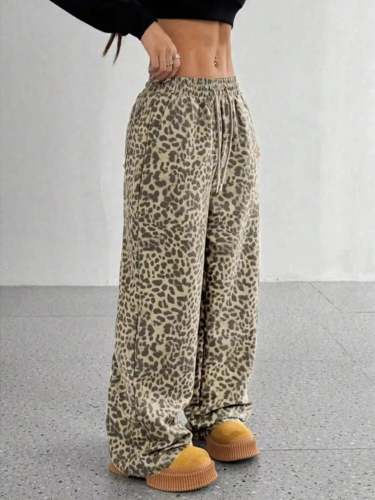 Plus size leopard print wide-leg pants by Trendsi, full-length view showing stylish, comfortable fit and bold animal print design.
