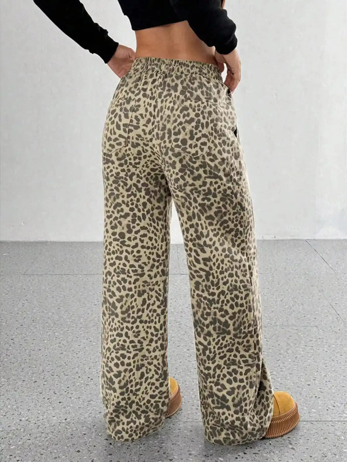 Plus size leopard print wide leg pants from Trendsi, featuring a full-length view of the stylish, flowy design.