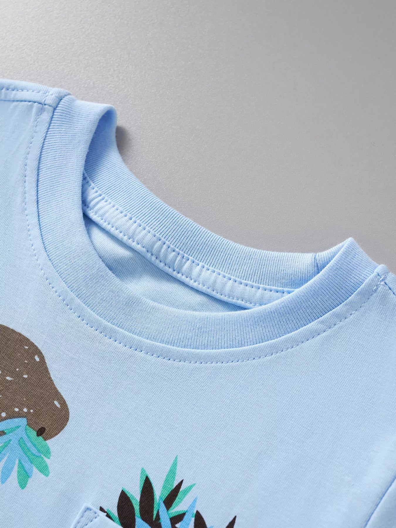 Light blue children's dinosaur round neck top and shorts set by Trendsi, perfect for casual wear for 3-year-olds.