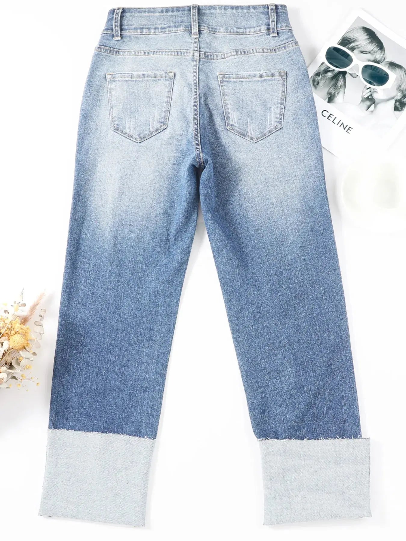 Light blue high waist distressed straight leg jeans by Trendsi, showing fit and stylish distressed details.