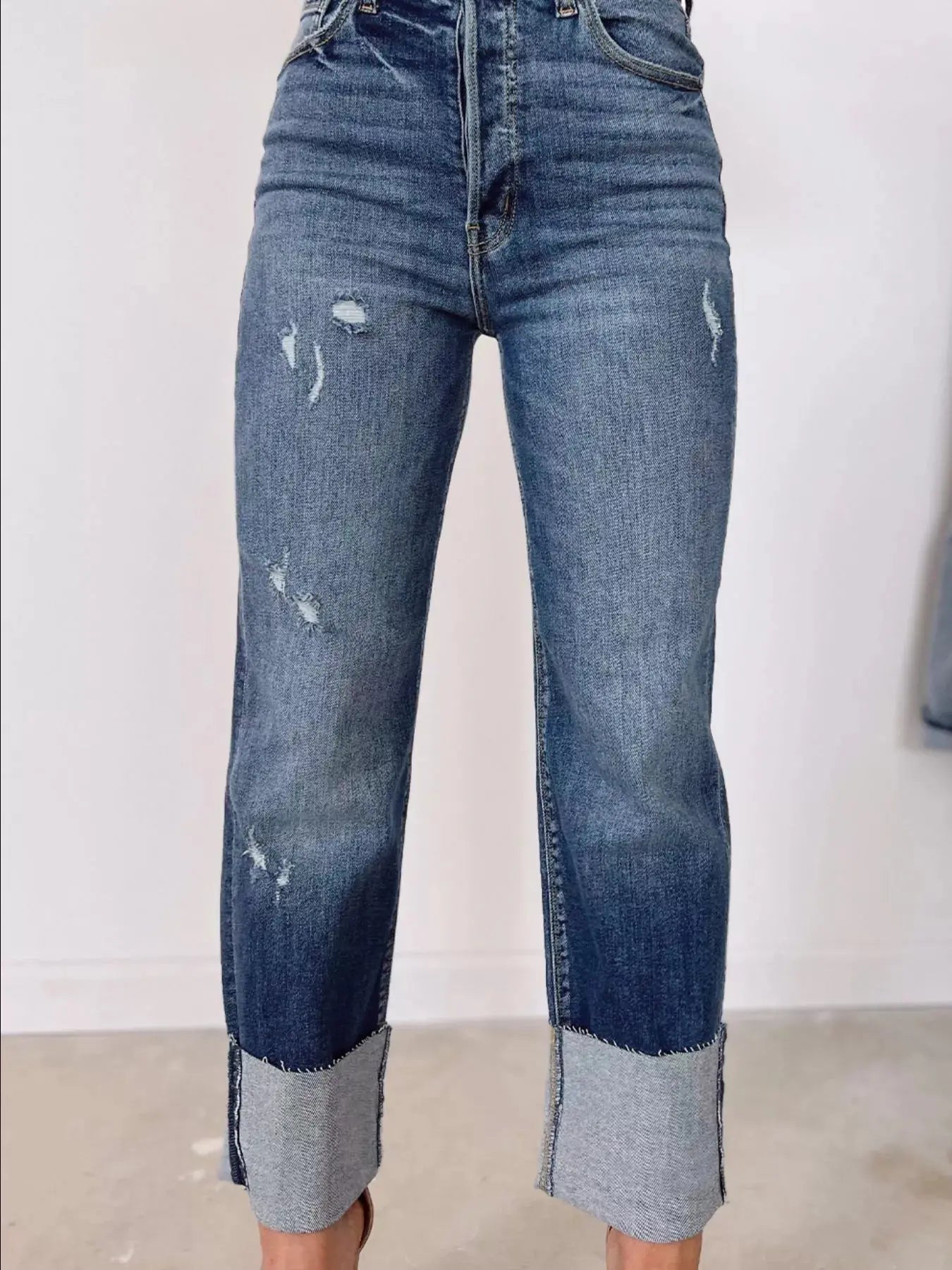 Light blue high waist distressed straight leg jeans from Trendsi, showing a relaxed fit with frayed details and classic denim texture.