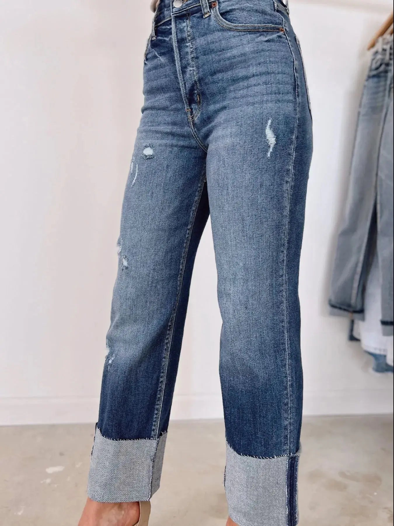 Light blue high-waist distressed straight leg jeans by Trendsi, showcasing frayed hems and classic denim style.