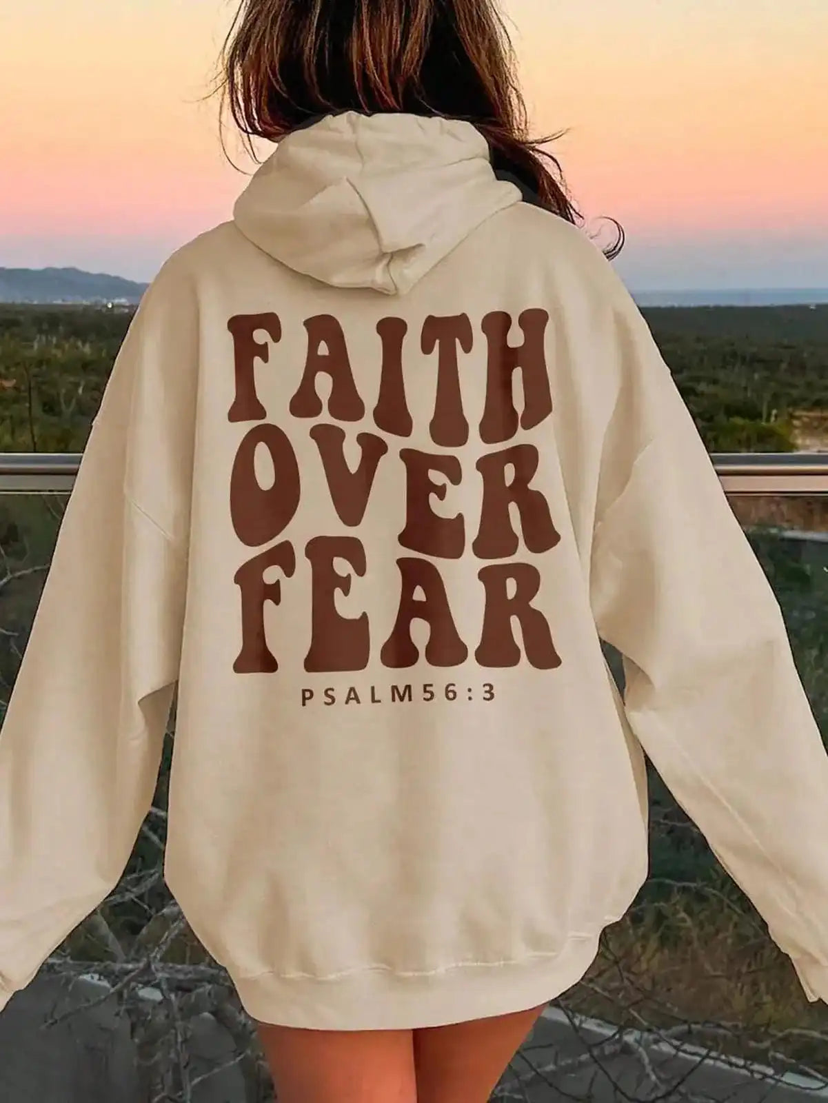 Pink dropped shoulder hoodie with "Faith Over Fear" graphic, casual fit, trendy style by Trendsi.
