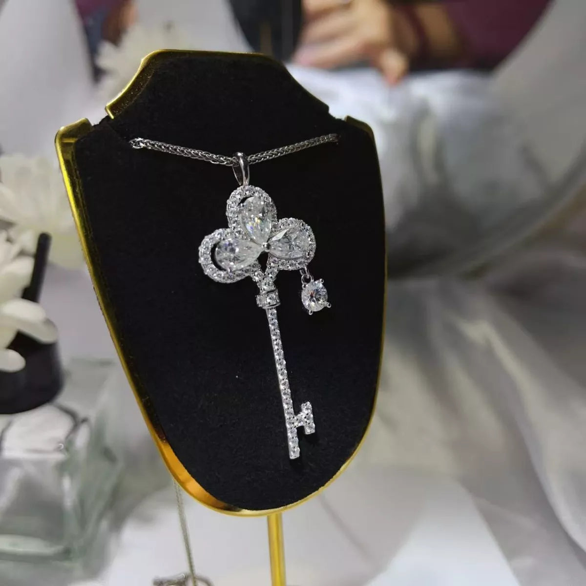 Sterling silver key necklace with 3.5 carat moissanite gemstone, featuring a sleek and elegant design.