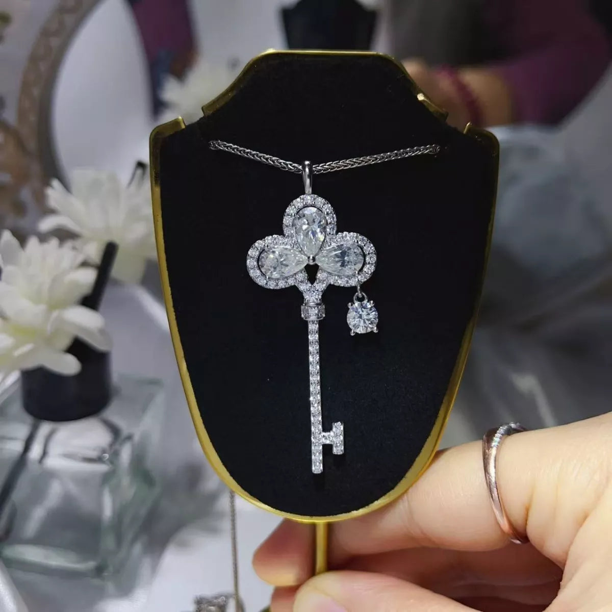 Sterling silver key necklace with 3.5-carat moissanite gemstone, featuring a delicate chain and elegant design.