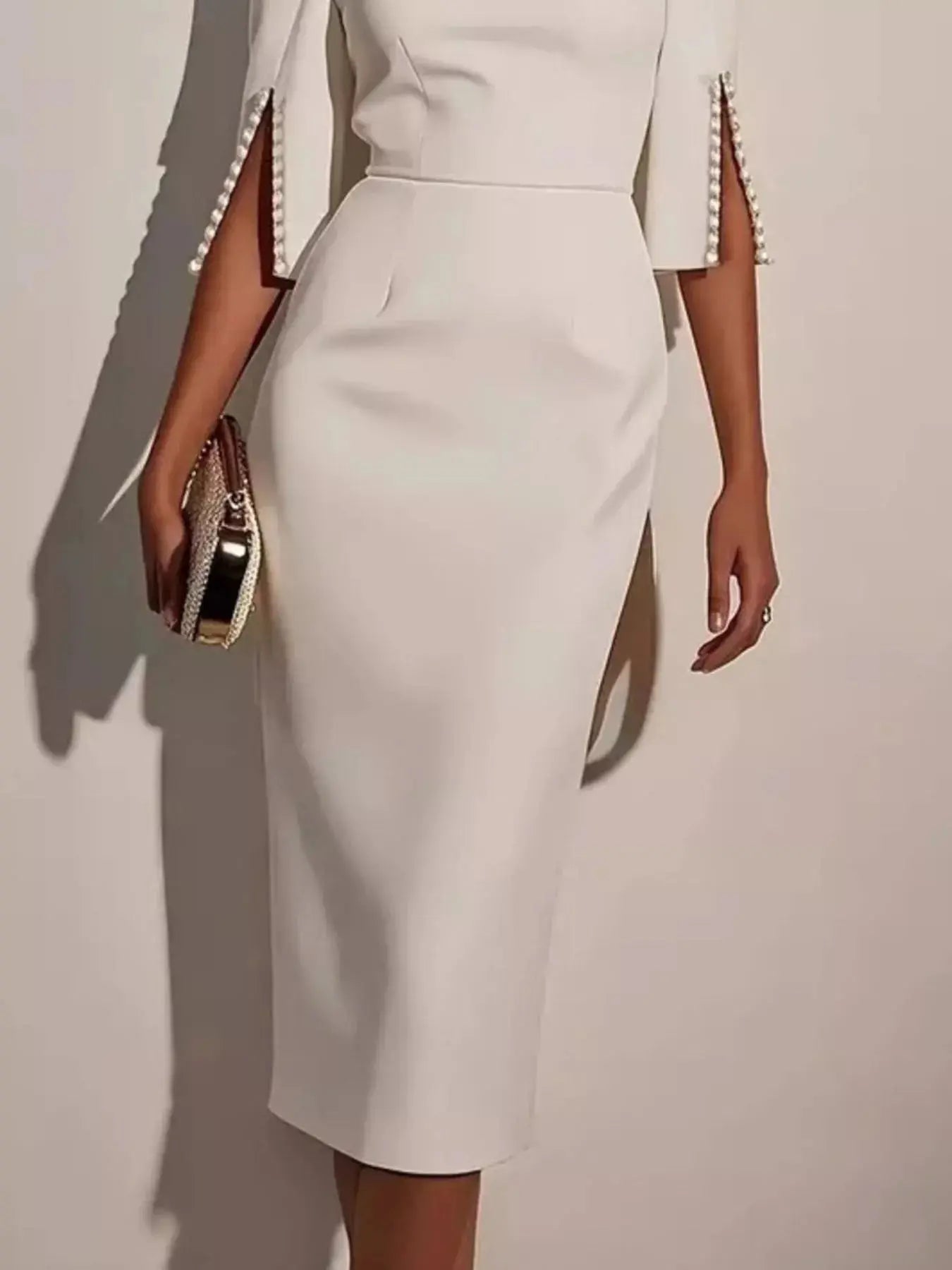White slim-fit elegant midi dress by Trendsi featuring beaded slit sleeves, perfect for stylish occasions.